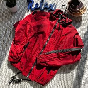 Red wind breaker jacket. Barely worn. Drawstrings attached.